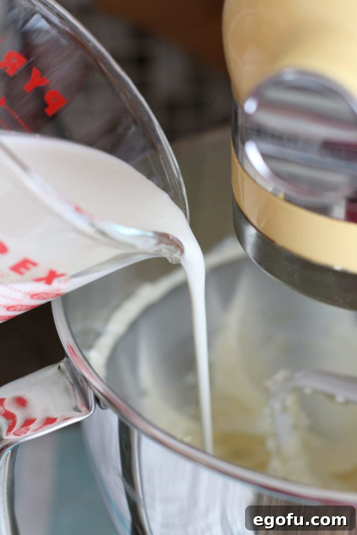 Zesty Lemon No-Bake Delight 6 adding heavy cream to cream cheese and sugar mixture in KitchenAid stand mixer.