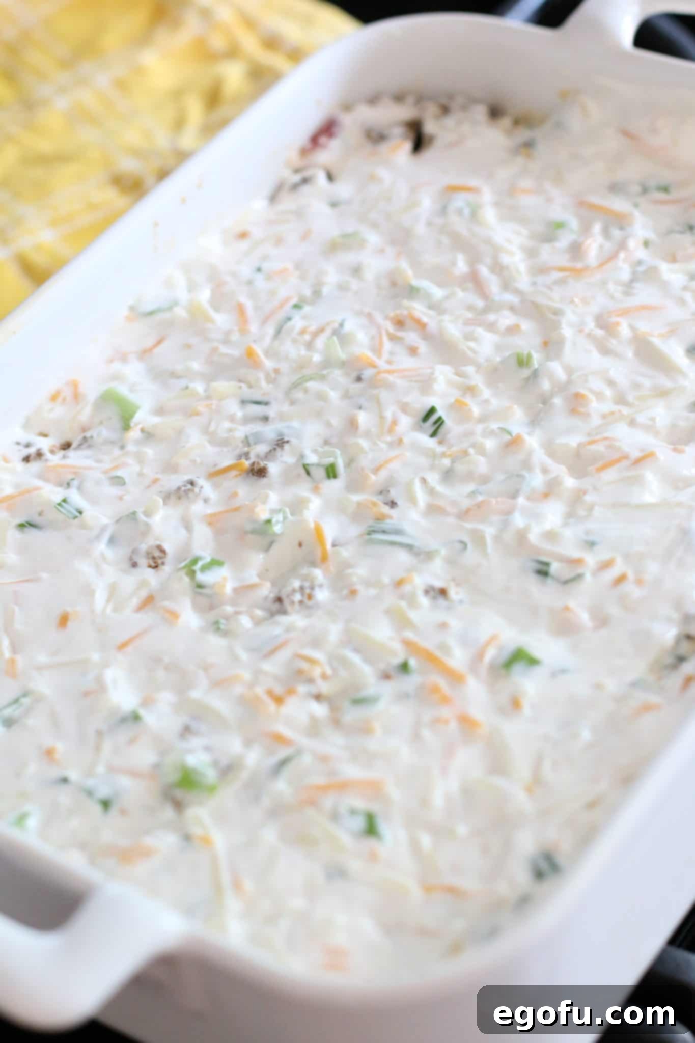 sour cream mixture layered on top of ground beef later in baking dish.