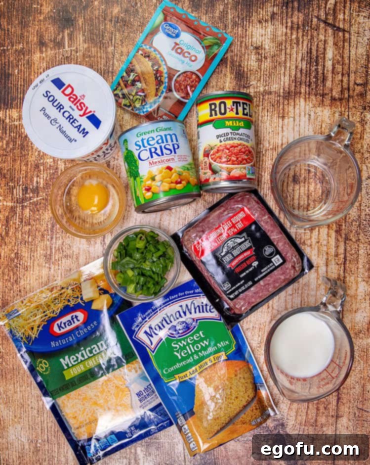 Cornbread Taco Bake ingredients: ground beef, cornbread mix, Mexican shredded cheese, Rotel, Mexicorn, sour cream, egg, taco seasoning, milk, green onion.