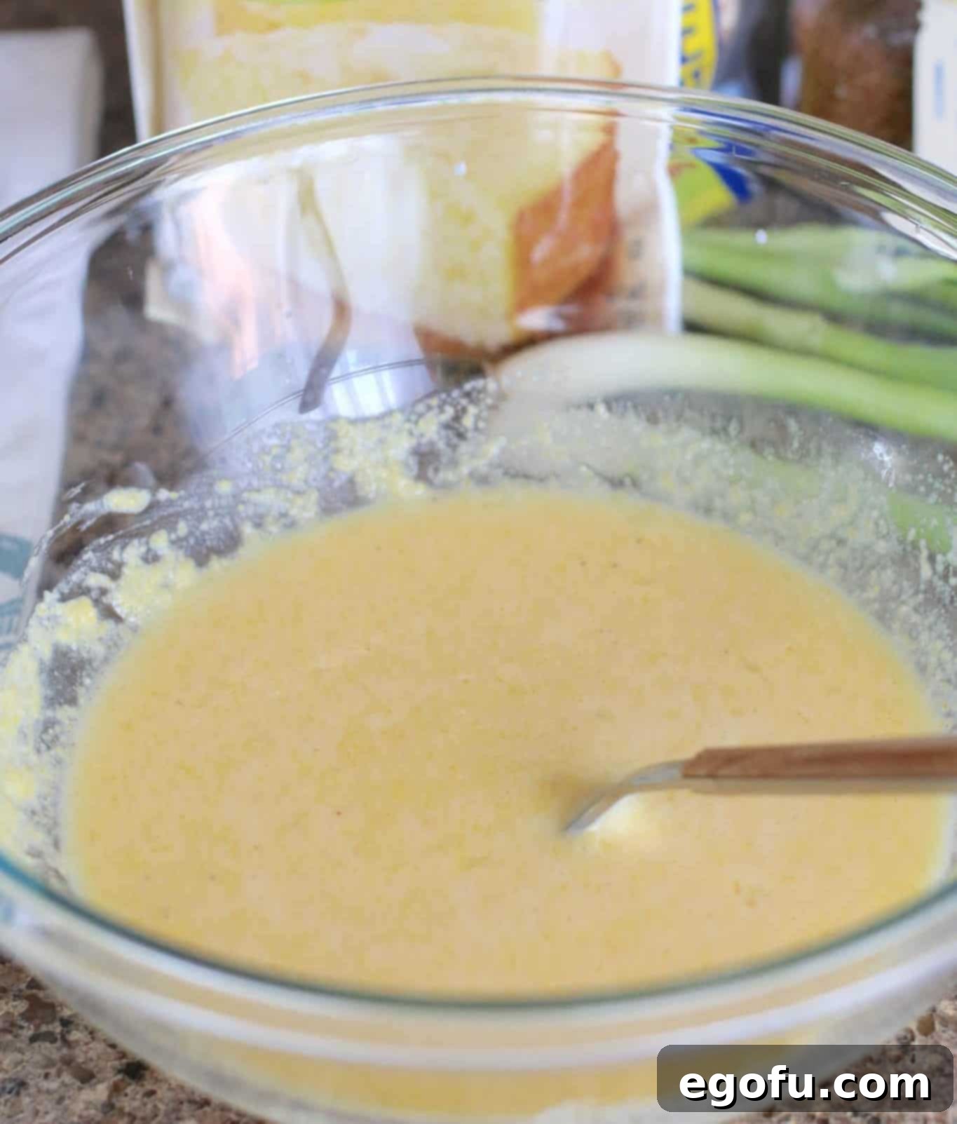 cornbread batter in a bowl with a fork.