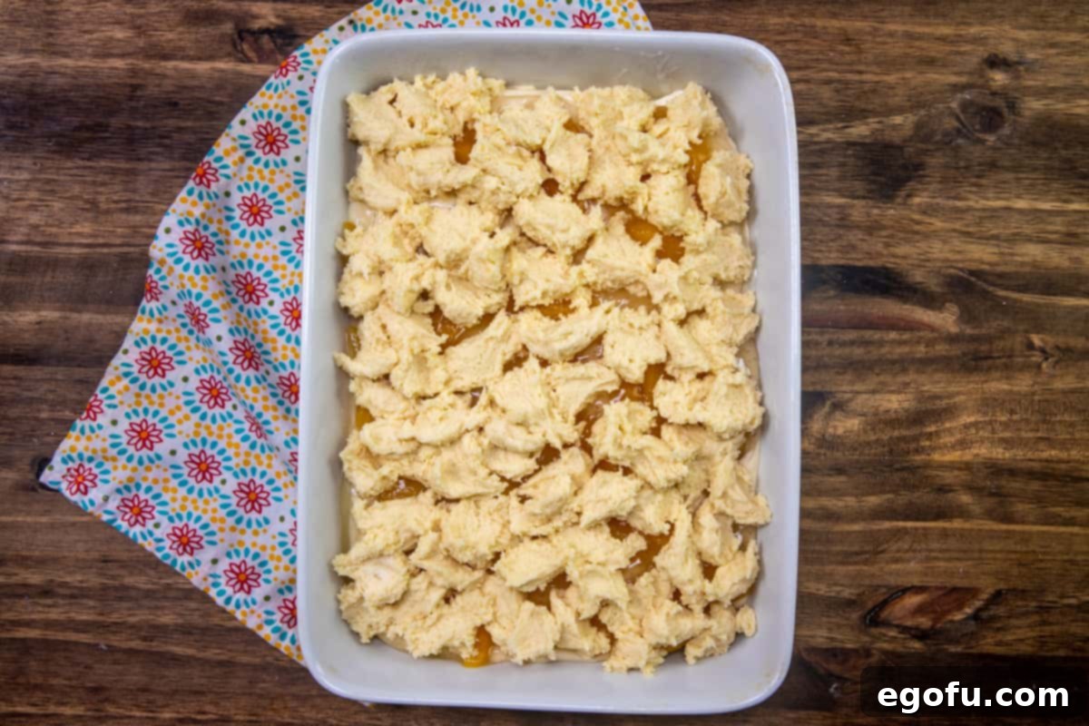 Velvet Peach Cream Bars 12 Chunks of the remaining cake batter are strategically dropped in dollops on top of the peach pie filling layer, creating a rustic, crumbly top that will bake into a beautiful crust.
