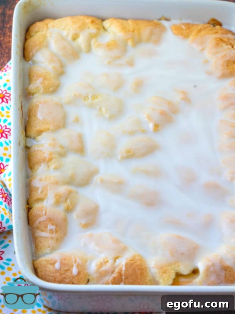 Velvet Peach Cream Bars 13 The fully baked Peaches and Cream Bars, beautifully glazed and resting in the pan, ready to be cut into individual servings, showcasing a perfect golden crust and glistening top.