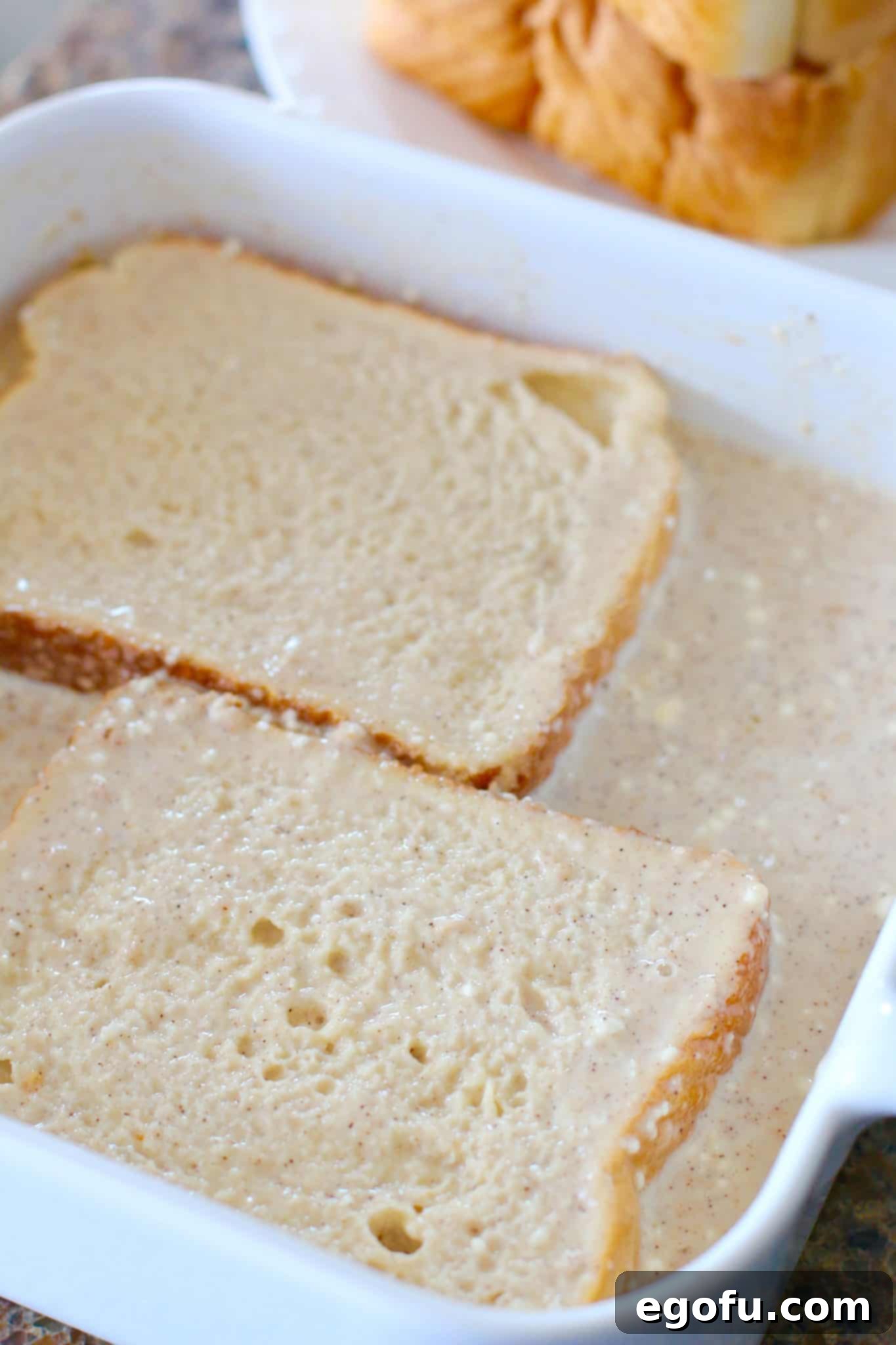 Pillowy French Toast Perfection 8 Texas Toast bread being dipped into the rich pancake-style batter.