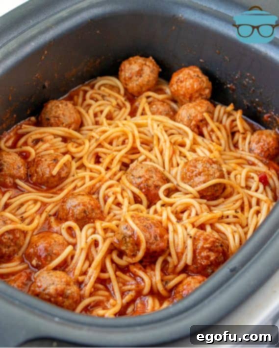 Effortless Slow Cooker Spaghetti and Meatballs 20 cooked spaghetti and meatballs shown in the slow cooker