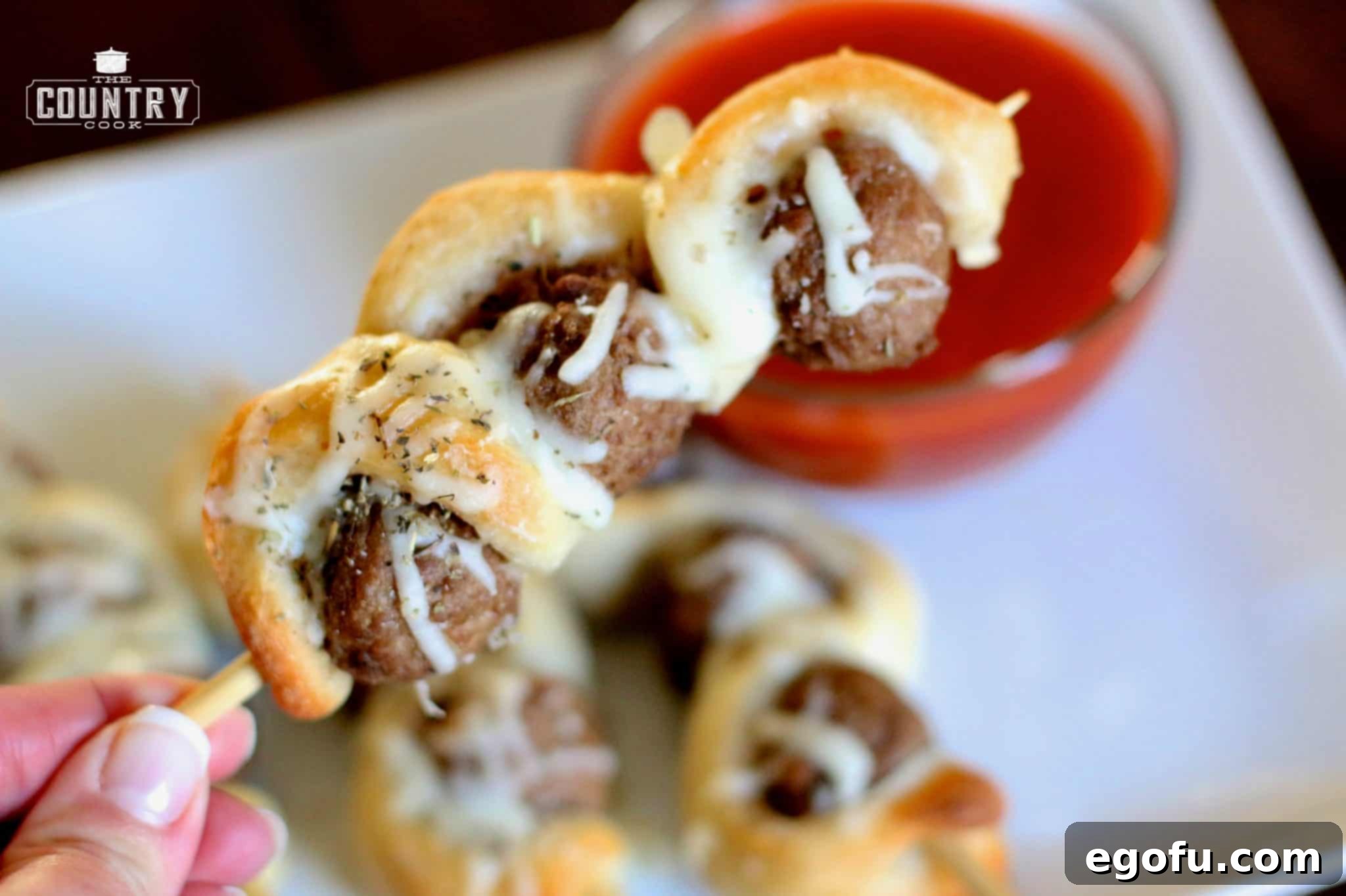 Delicious Meatball Sub on a Stick, showcasing the golden-brown breadstick dough wrapped around meatballs, perfect for an appetizer.