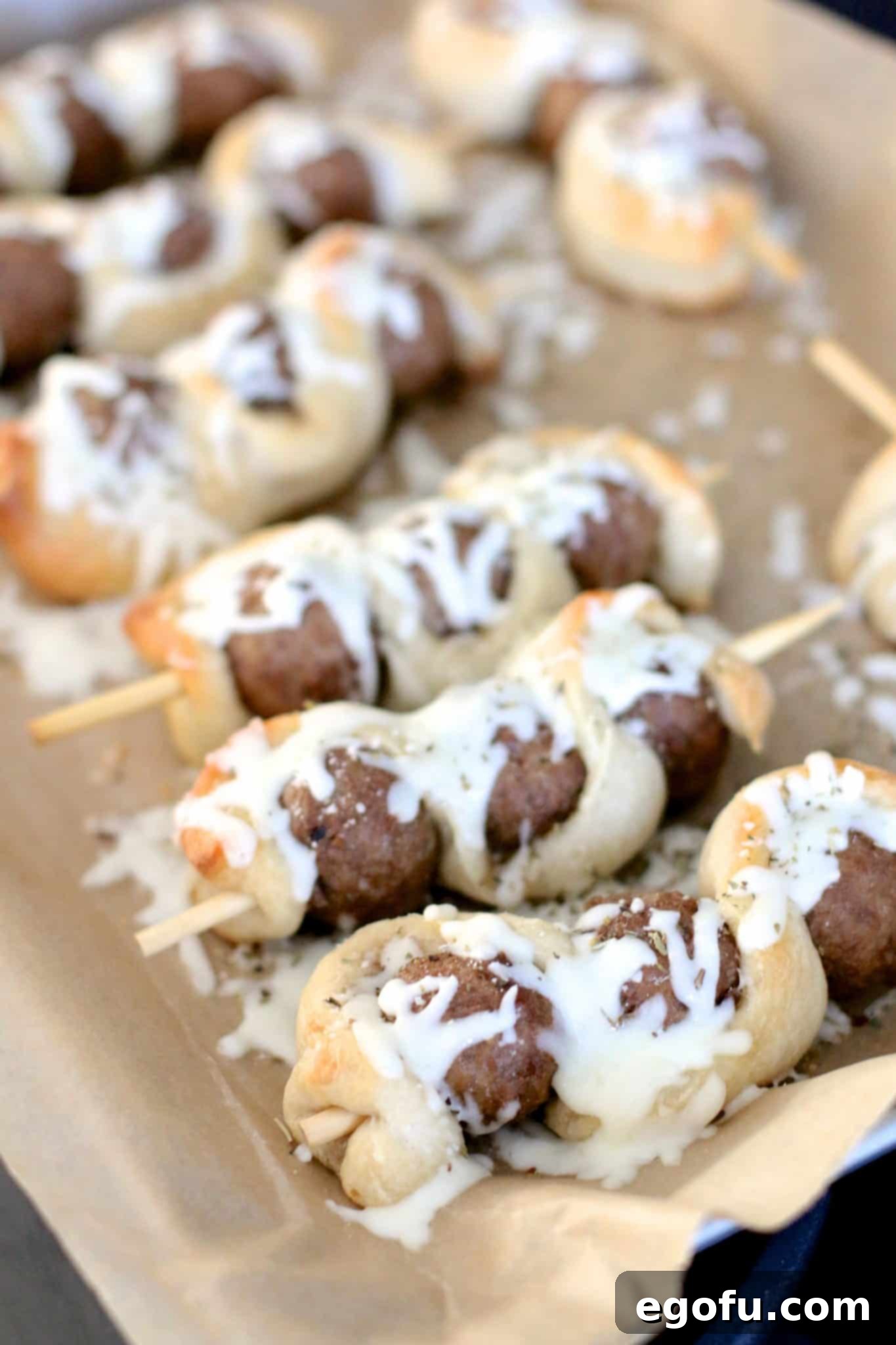 Meatball subs on sticks with perfectly melted, bubbly mozzarella cheese after the final short bake.