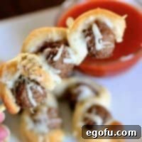 Finished Meatball Sub on a Stick appetizer, golden brown with melted cheese and ready for dipping.