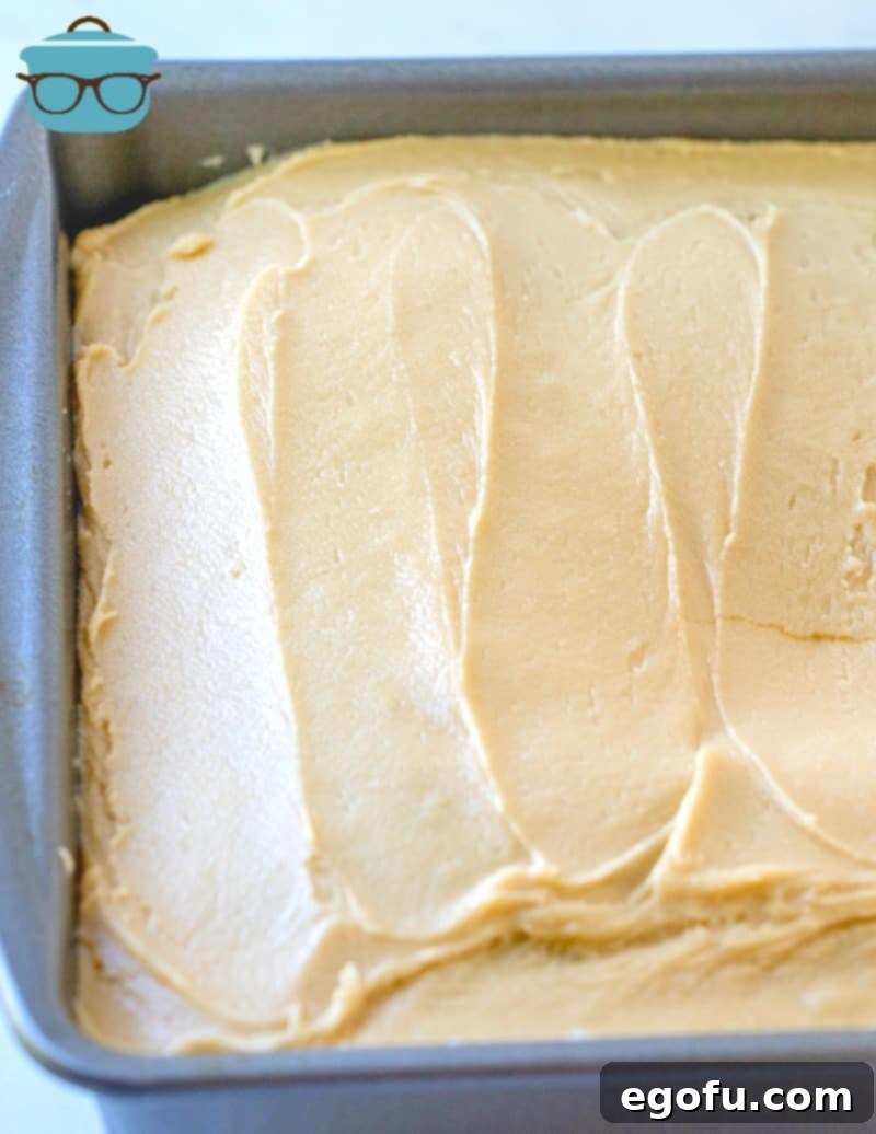 brown sugar frosting spread onto chocolate cake.