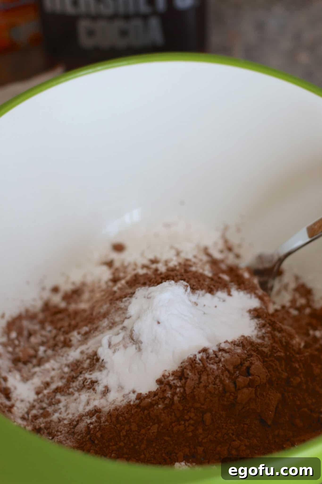 flour, baking soda and cocoa mixed together in a bowl.