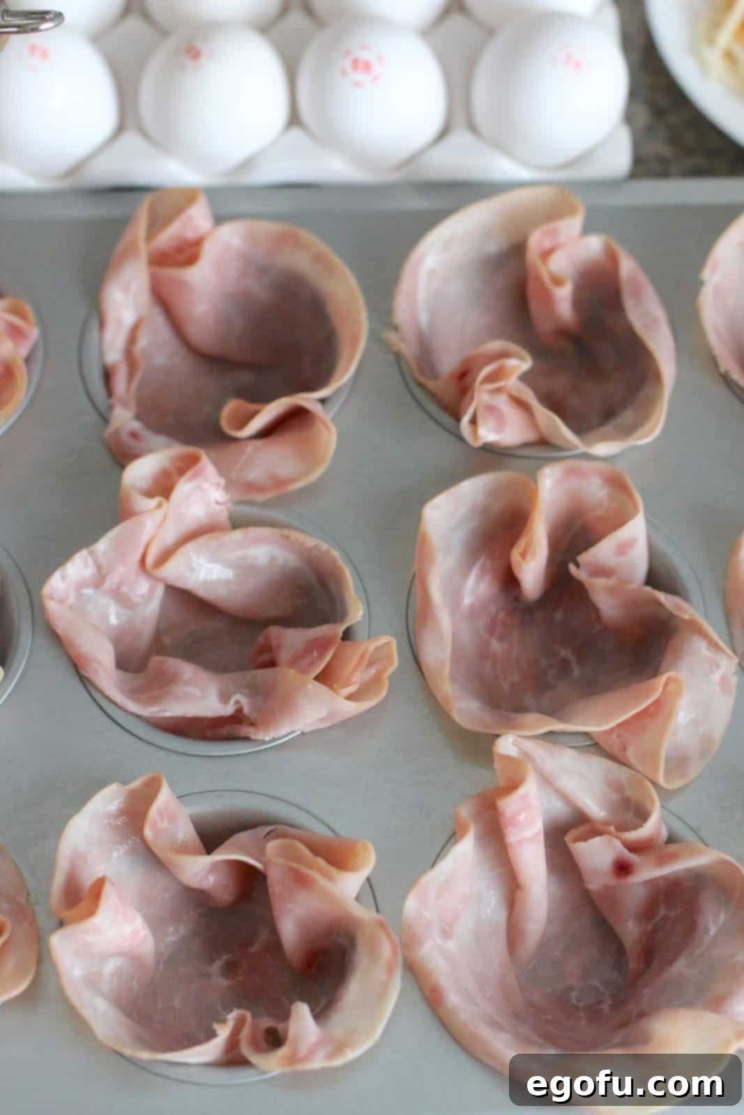 Breakfast Ham and Egg Nests 6 ham slices spread into a muffin tin.