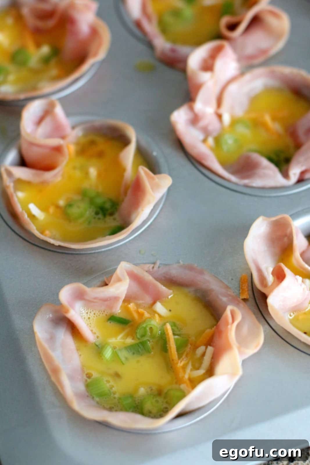 Breakfast Ham and Egg Nests 10 egg mixture added to ham slices in muffin tin.