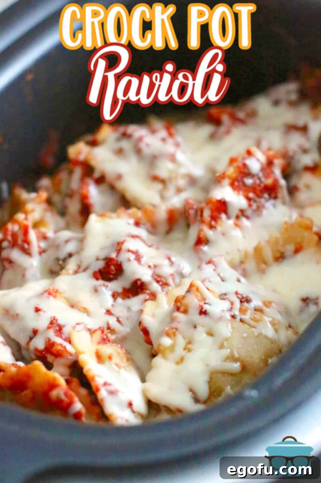 Cooked ravioli with melted cheese on top in a slow cooker, ready to serve.