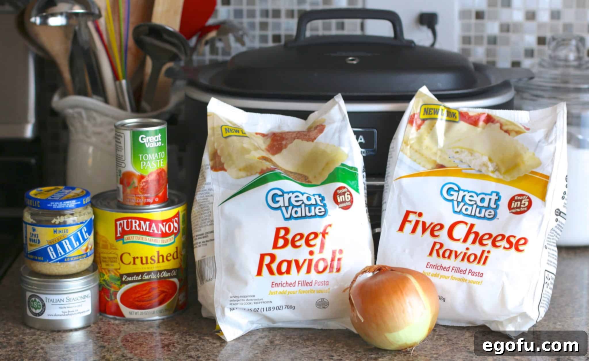 Ingredients for crock pot ravioli: frozen beef ravioli, frozen cheese ravioli, crushed tomatoes, tomato sauce, diced onion, Italian seasoning, minced garlic, all neatly arranged.