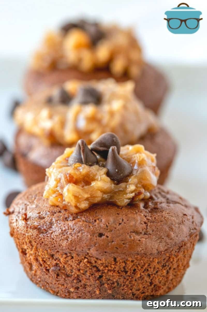 Finished German Chocolate Chip Muffins arranged beautifully on a white tray, topped with frosting and chocolate chips.