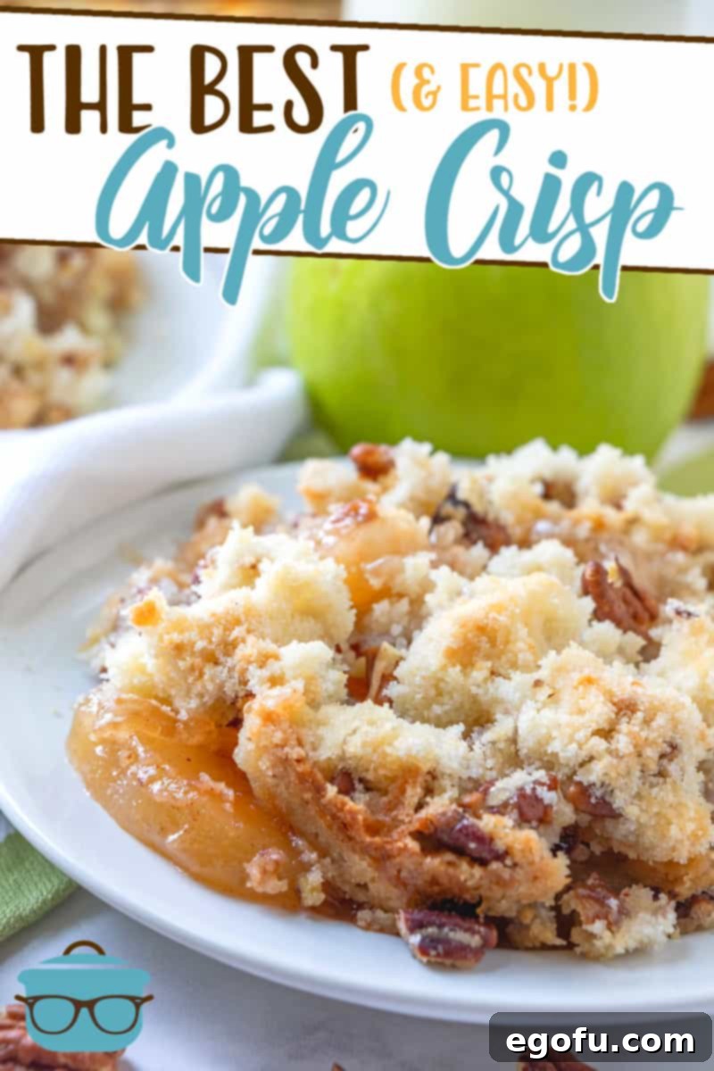 Effortless Apple Crisp 3 The Best Apple Crisp recipe served on a small white plate with whole apples in the background, highlighting its rustic charm.
