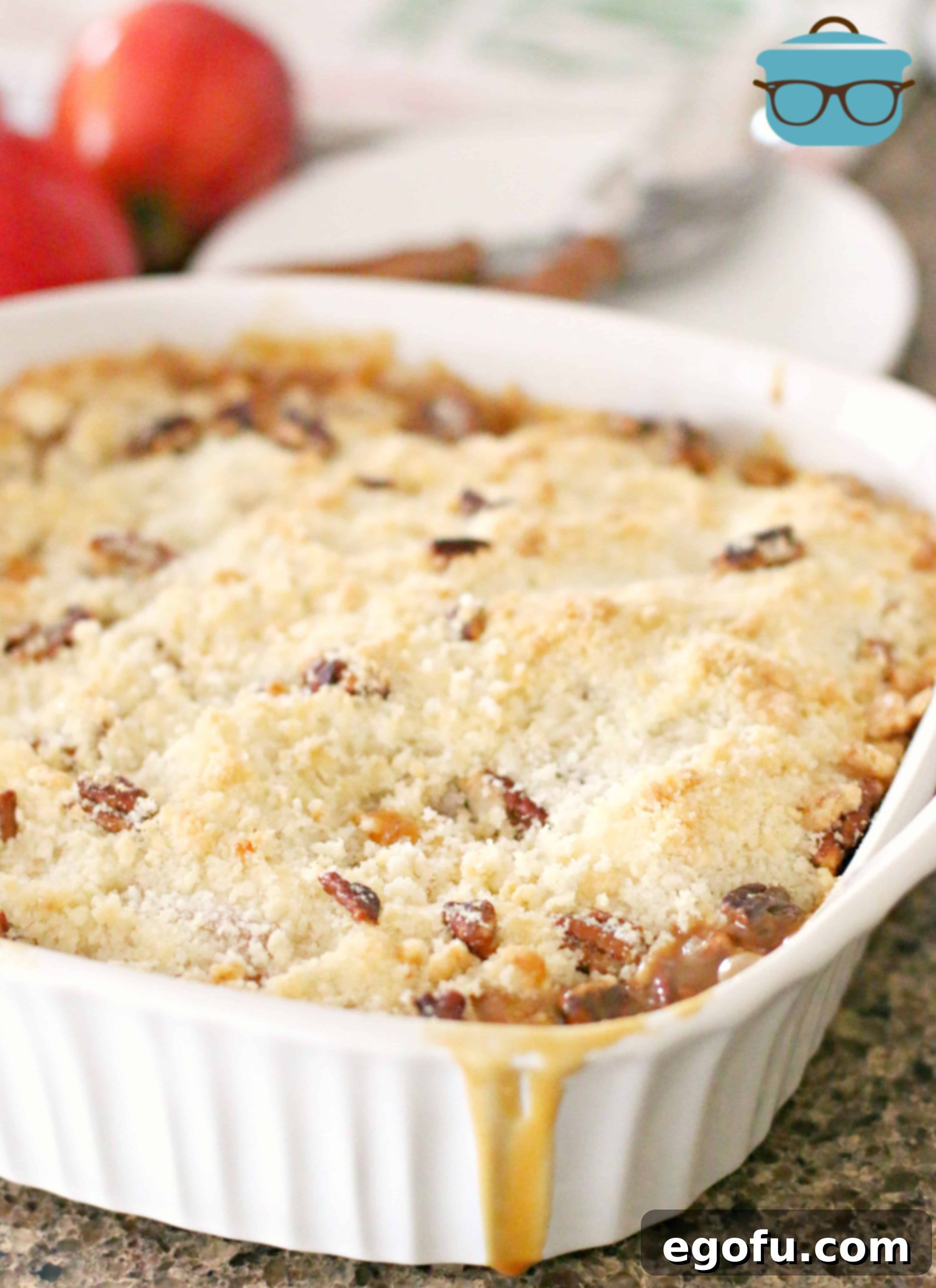 Effortless Apple Crisp 6 Finished baked apple crisp in a white baking dish, golden brown and bubbly from the oven.