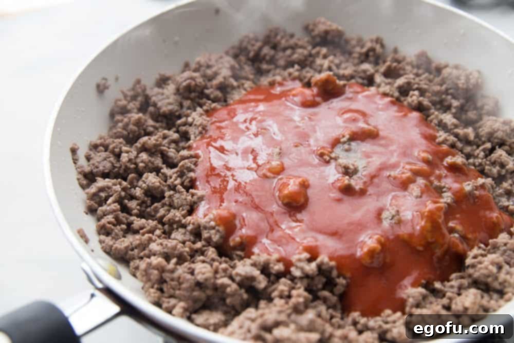 cooked ground beef with taco sauce in a skillet. 