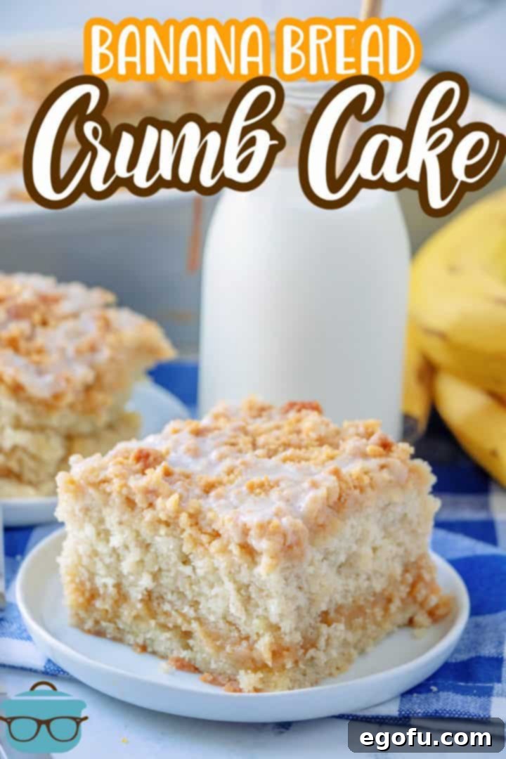 A perfectly sliced piece of Banana Bread Crumb Cake on a white plate, showcasing the distinct layers of moist cake and crumb topping, with a small milk bottle in the background.