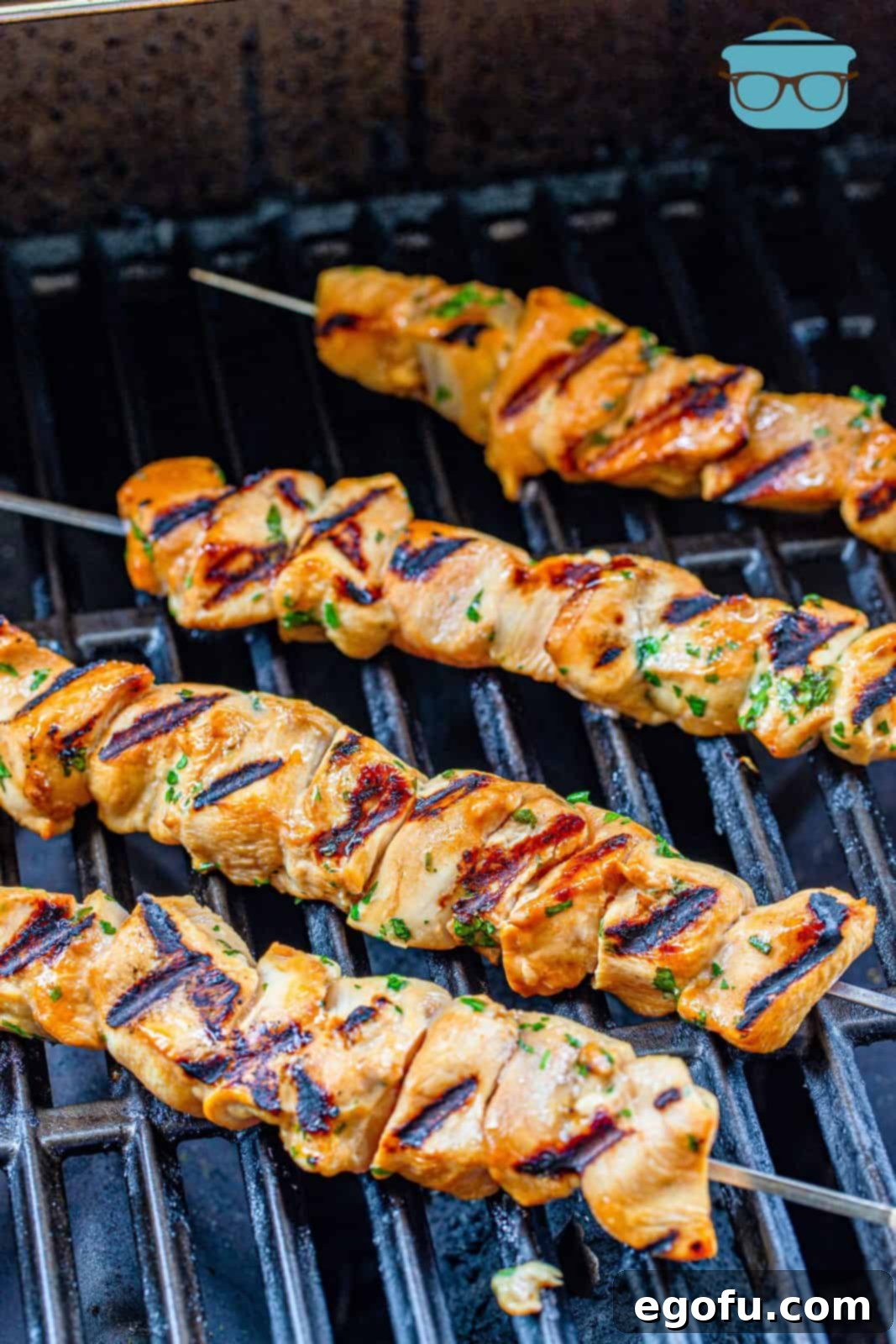 fully cooked and grilled chicken skewers on the grill.