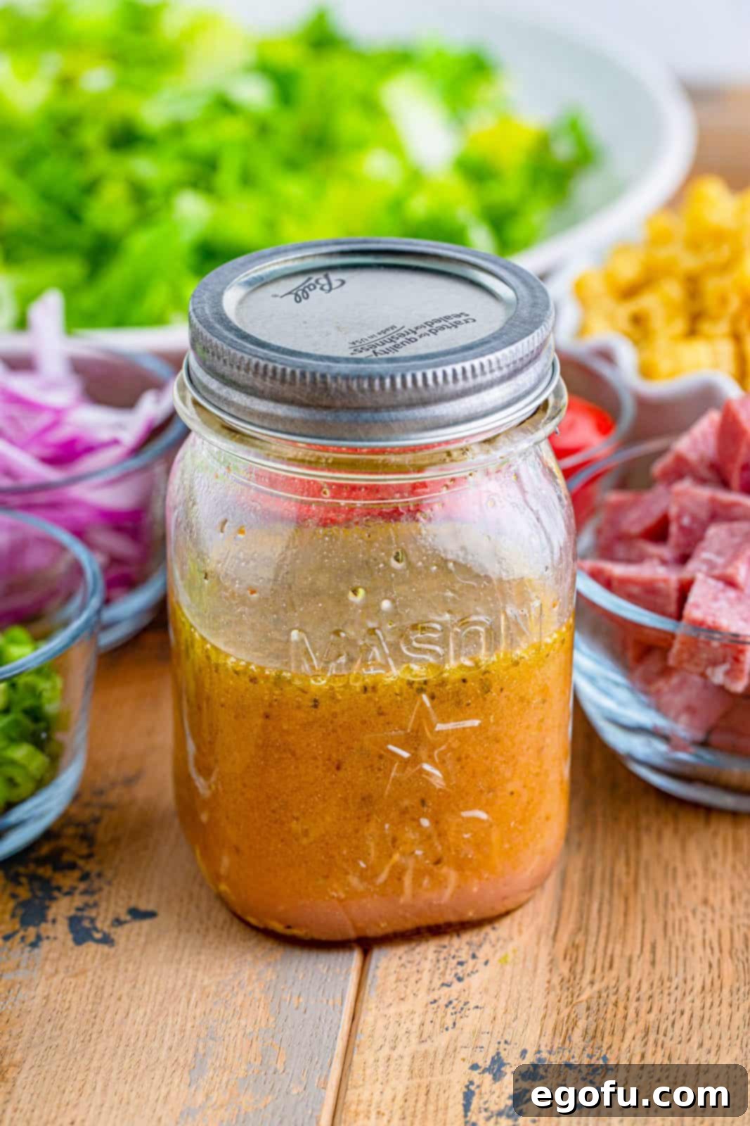 Vibrant Italian Chopped Salad 7 prepared salad dressing shown completely combined in a mason jar.