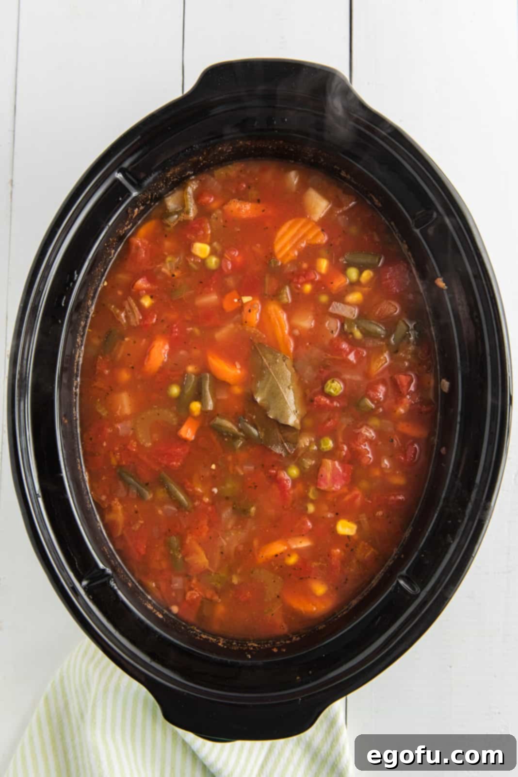 One Pot Comfort Vegetable Soup 9 Overhead view of the finished Crock Pot Vegetable Soup, steaming gently in the slow cooker after hours of cooking.
