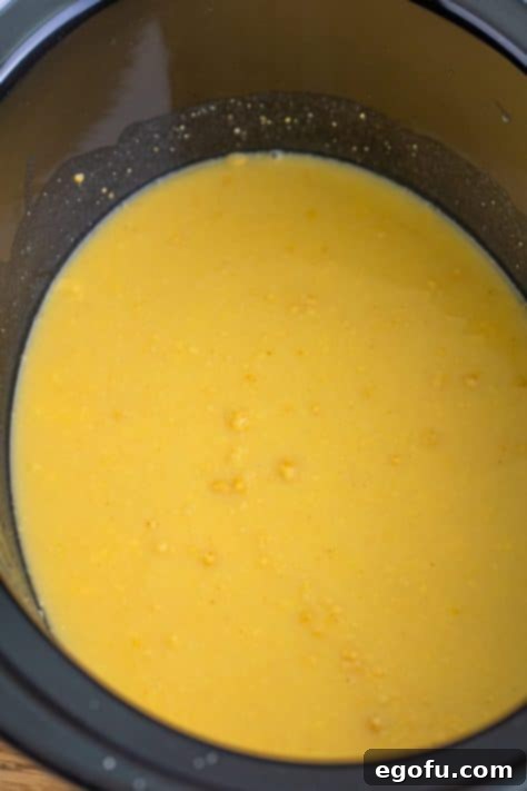 A crock pot with the chicken gravy mix, cream of chicken soup and water.