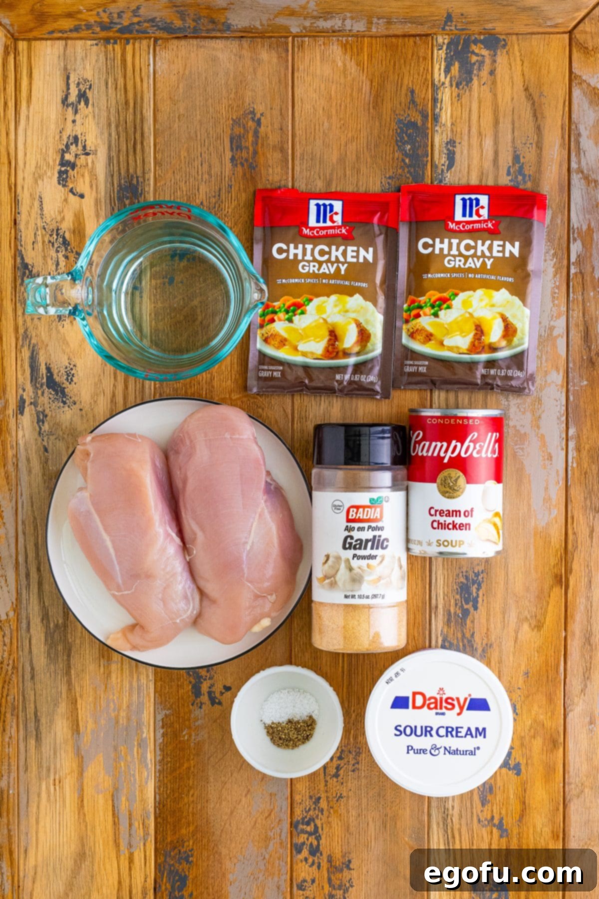 A visual display of the main ingredients: chicken breasts, cream of chicken soup, chicken gravy mix, water, garlic powder, salt, pepper, and sour cream.