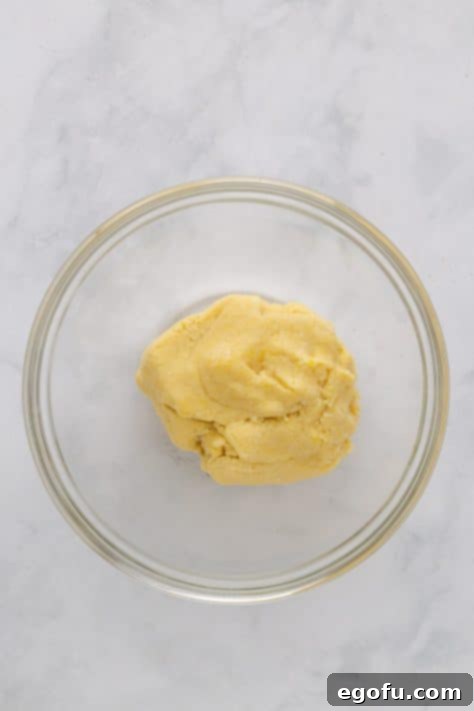 Cookie dough being mixed in a bowl.