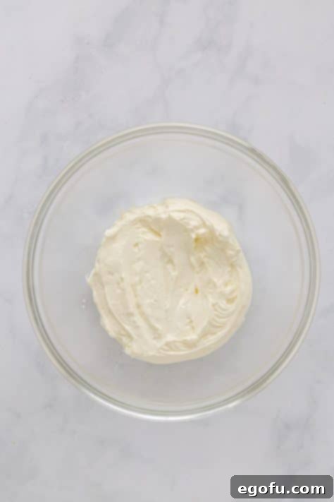 Melted white chocolate and cream cheese mixture in a bowl.