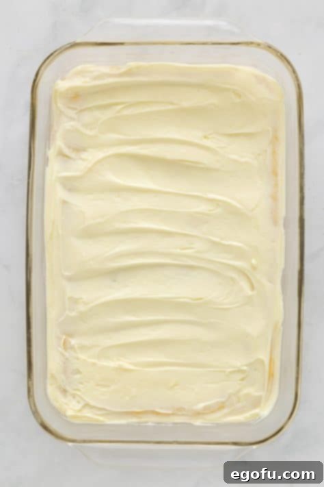 White chocolate cream cheese mixture spread over the cookie dough layer.