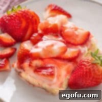 Looking closer at a single Strawberries and Cream Bar, showing its detailed layers and fresh fruit.