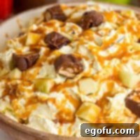 Creamy Snickers Apple Delight 11 A close up bowl of Snickers Apple Salad with caramel drizzle.