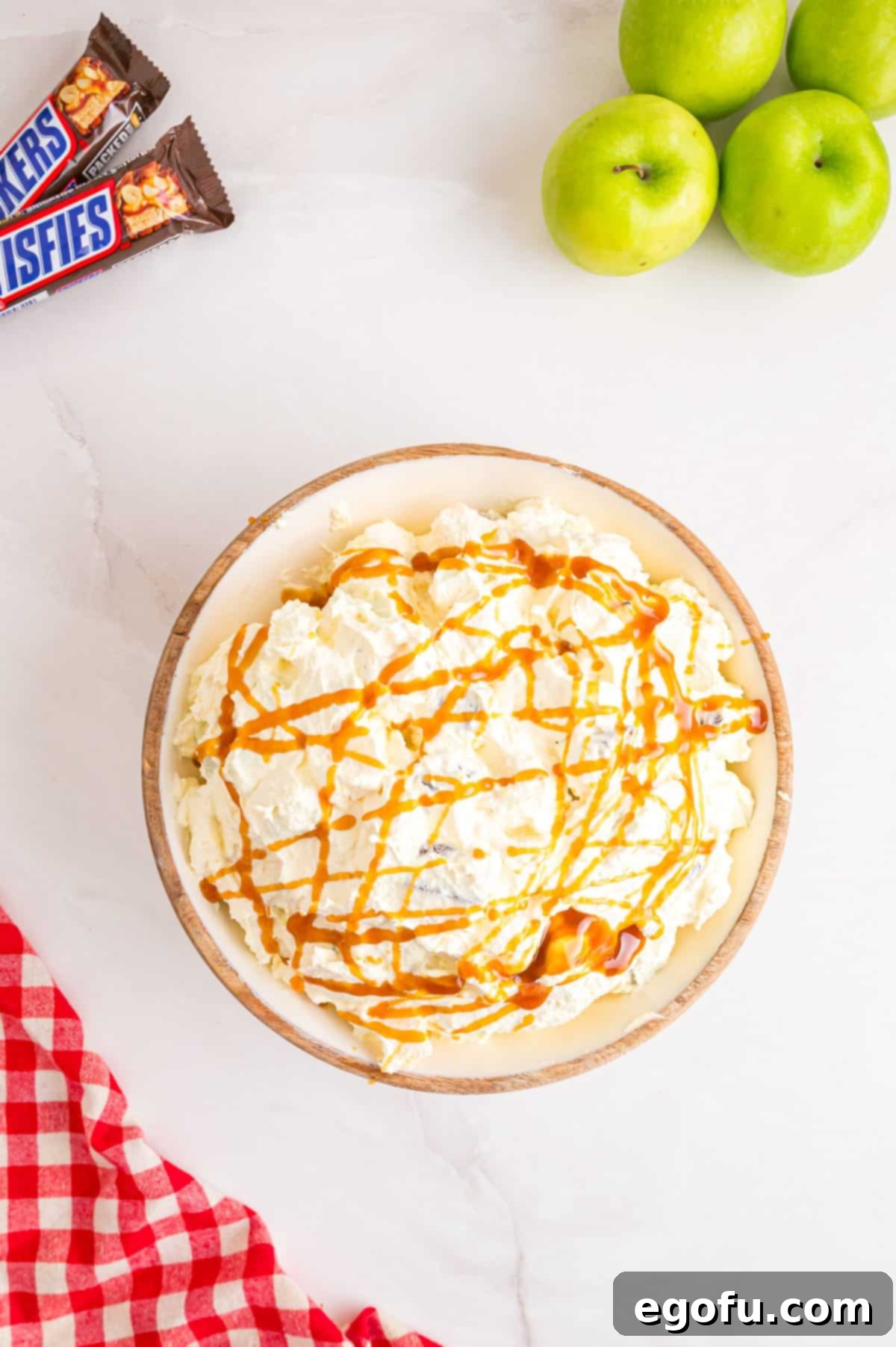 Creamy Snickers Apple Delight 7 Caramel drizzled Snickers Apple Salad in a bowl.