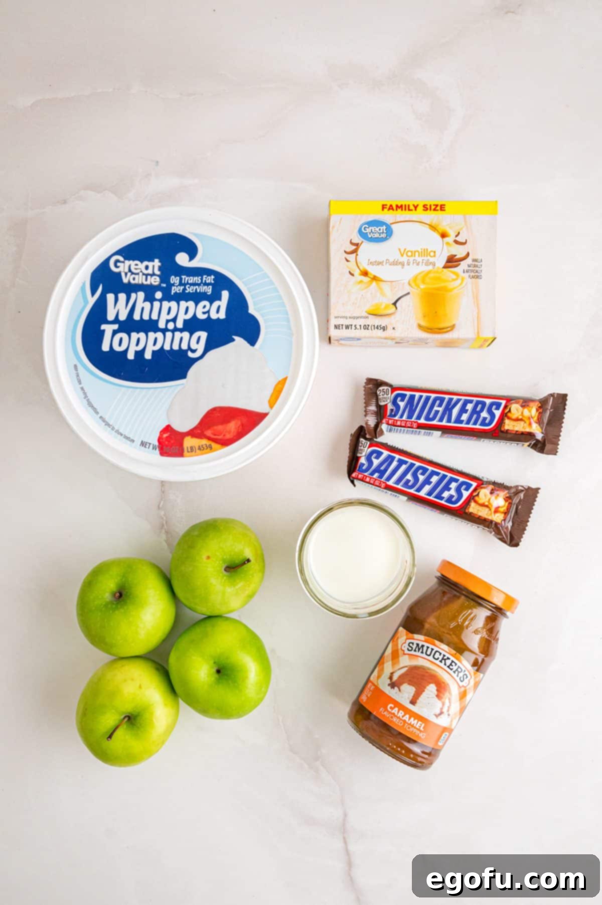 Creamy Snickers Apple Delight 10 Whipped topping, vanilla pudding, apples, Snickers bars, milk, and caramel sauce.