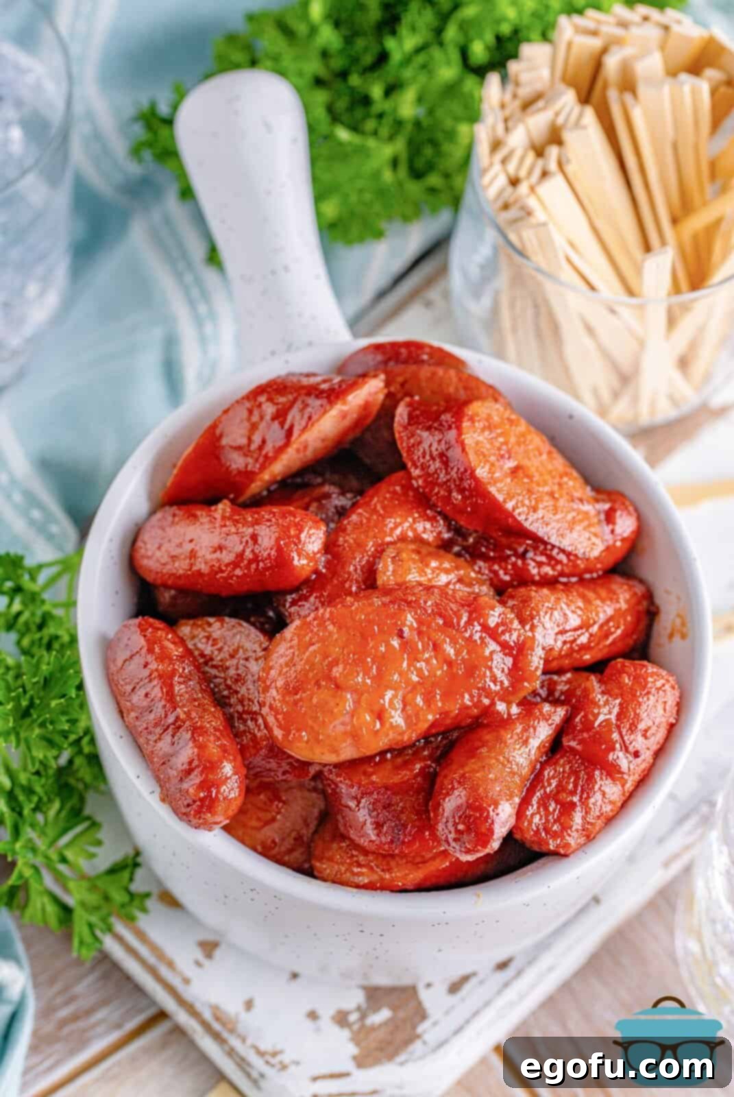 glazed sausage bites shown in a white bowl with a handle.