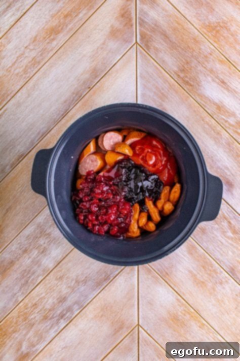 sliced kielbasa, Lit'l smokies, grape jelly, ketchup and cranberry jelly in a slow cooker.