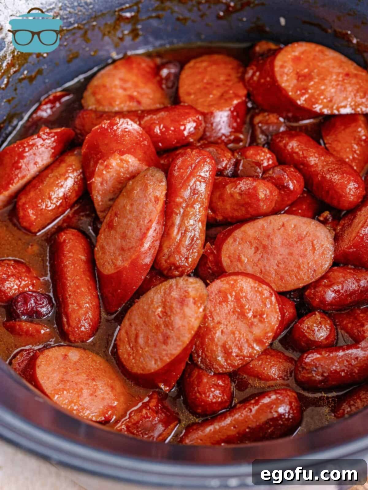 fully cooked sausage bites in a round slow cooker.