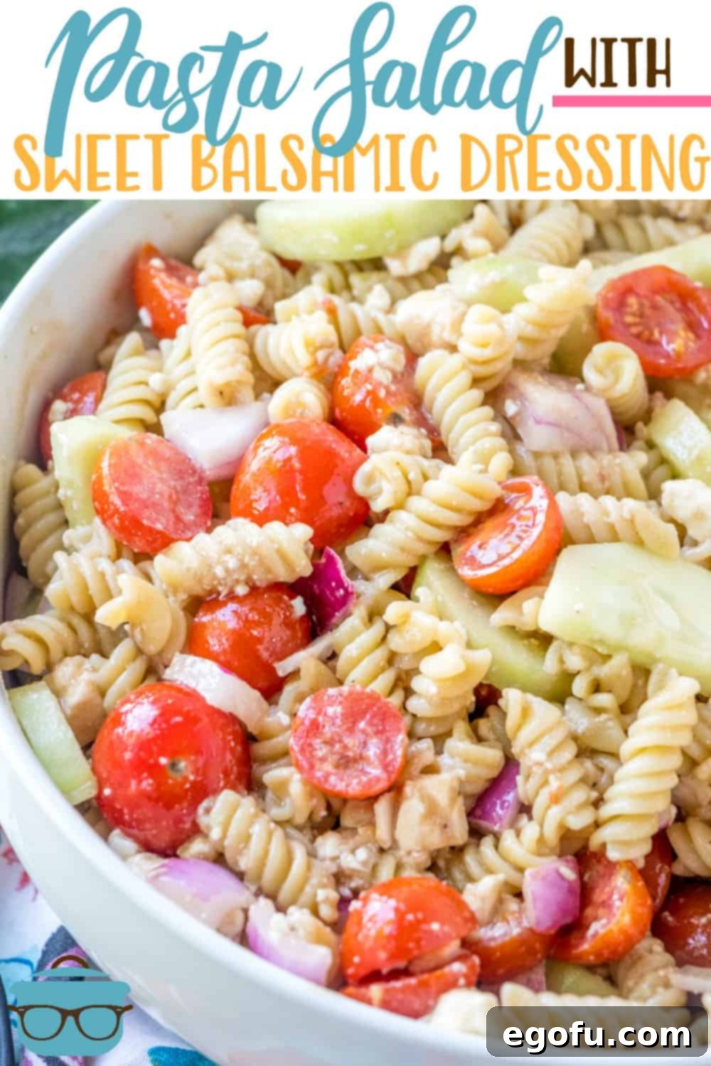 A large serving bowl filled with a refreshing Pasta Salad with Sweet Balsamic Dressing, featuring rotini pasta, feta, cucumbers, and tomatoes.
