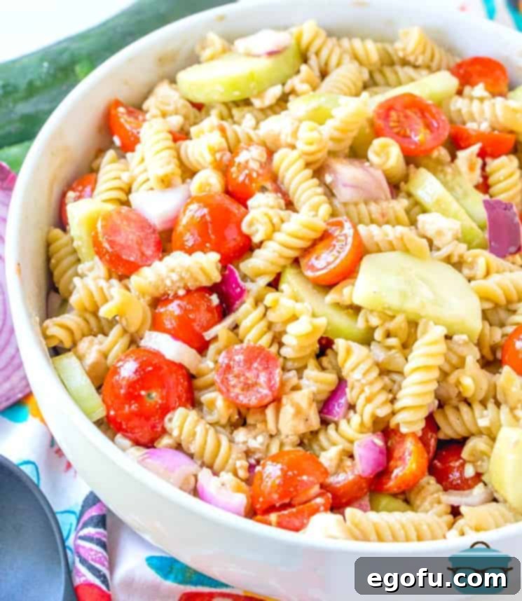 A close-up of the finished Pasta Salad with Sweet Balsamic Dressing, showing rotini pasta, feta cheese, cucumbers, and tomatoes perfectly coated and ready to enjoy.
