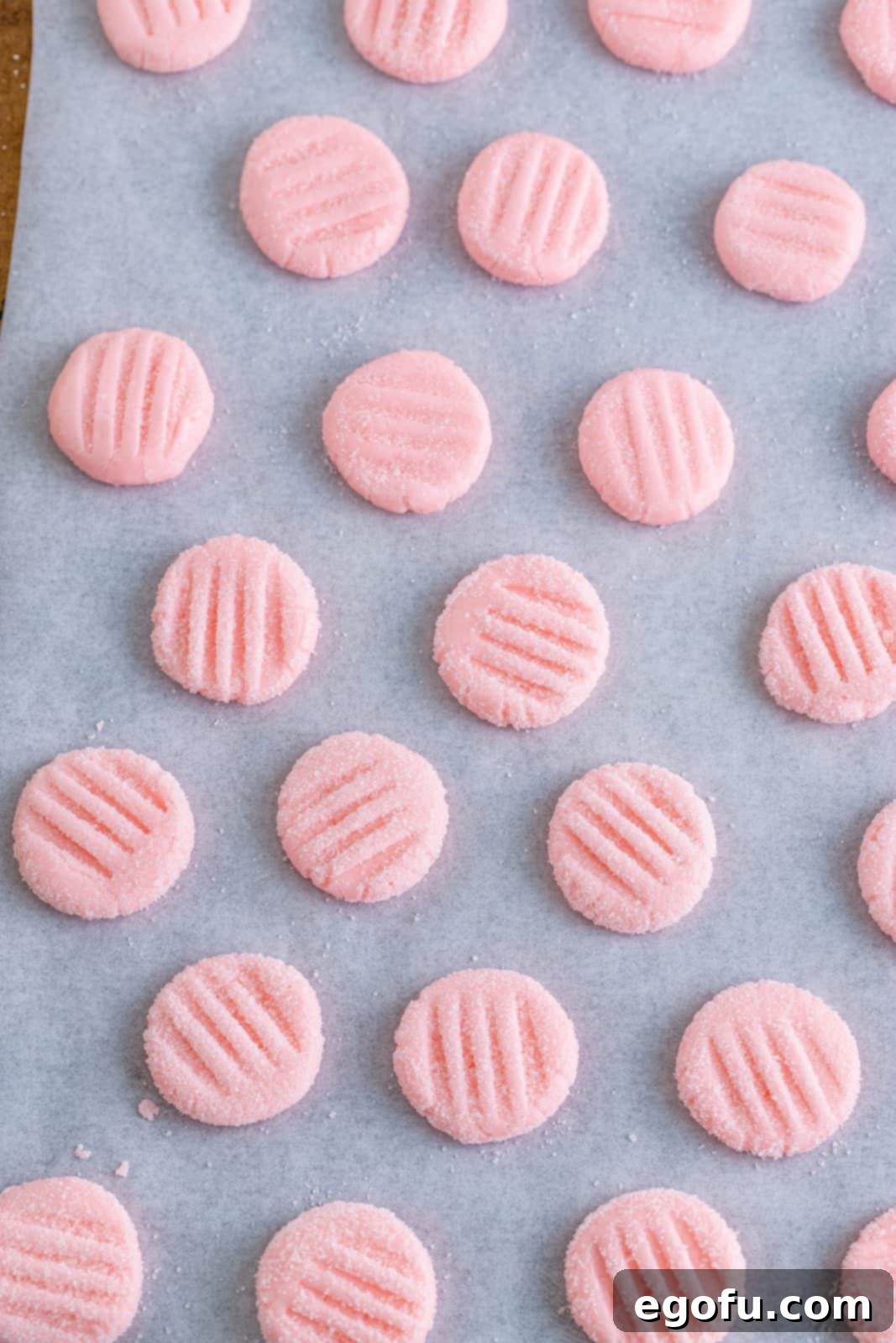 Refreshing Finales 11 Neatly arranged, fully made cream cheese mints, sugar-coated and textured with a fork, resting on parchment paper on a baking sheet, ready for chilling.