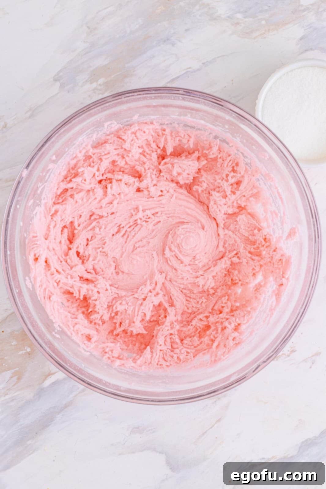 Refreshing Finales 5 Vibrant red cream cheese and food coloring mixture, perfectly blended in a clear mixing bowl, ready for the next step.