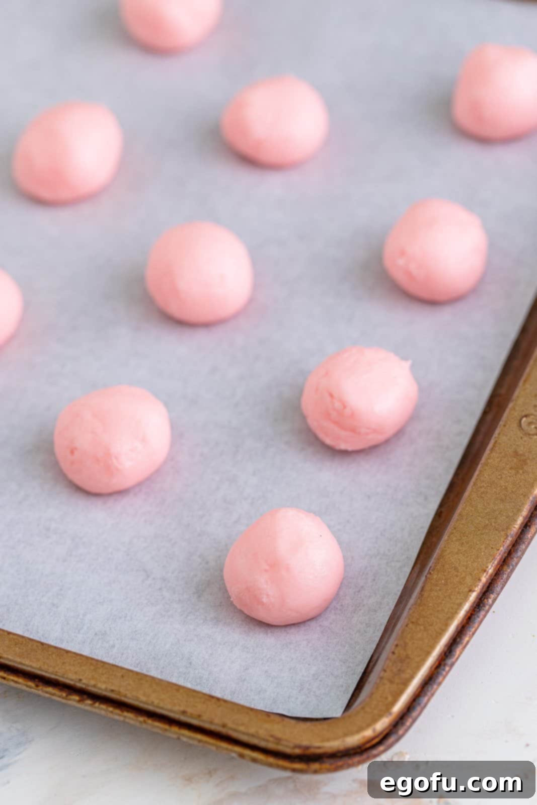 Refreshing Finales 8 Small, perfectly rolled cream cheese mint balls arranged neatly on a parchment paper-lined baking sheet, ready for the next step.
