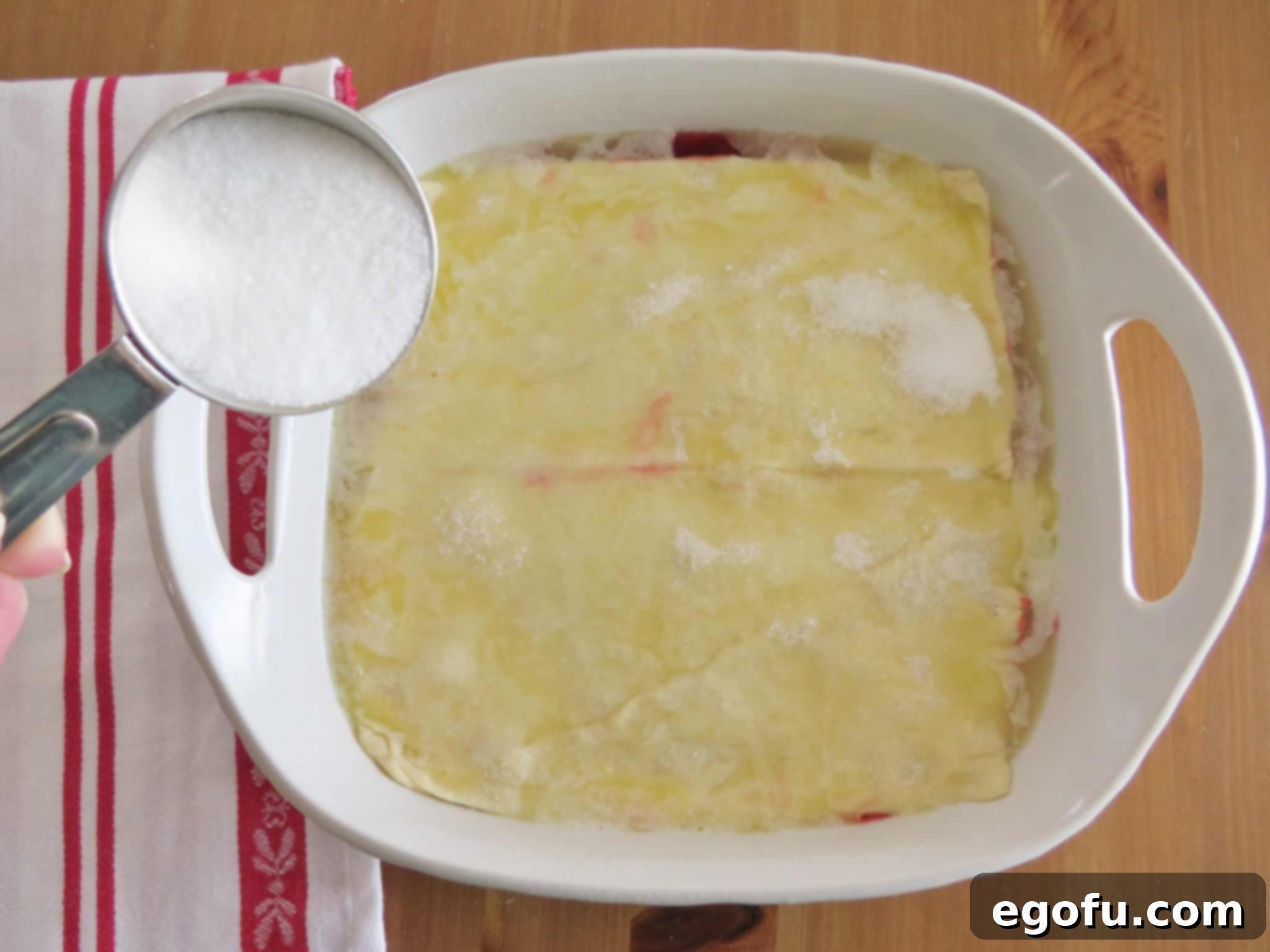 sprinkling granulated sugar on top of melted butter.