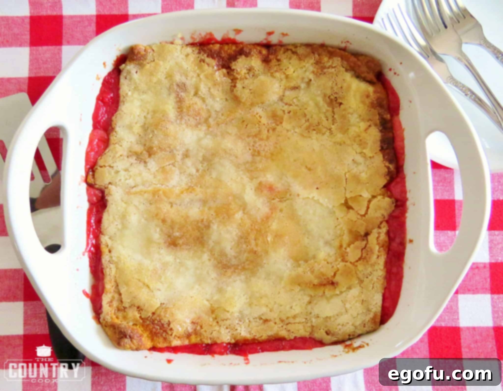 finished baking image of cherry cheesecake cobbler in baking dish.
