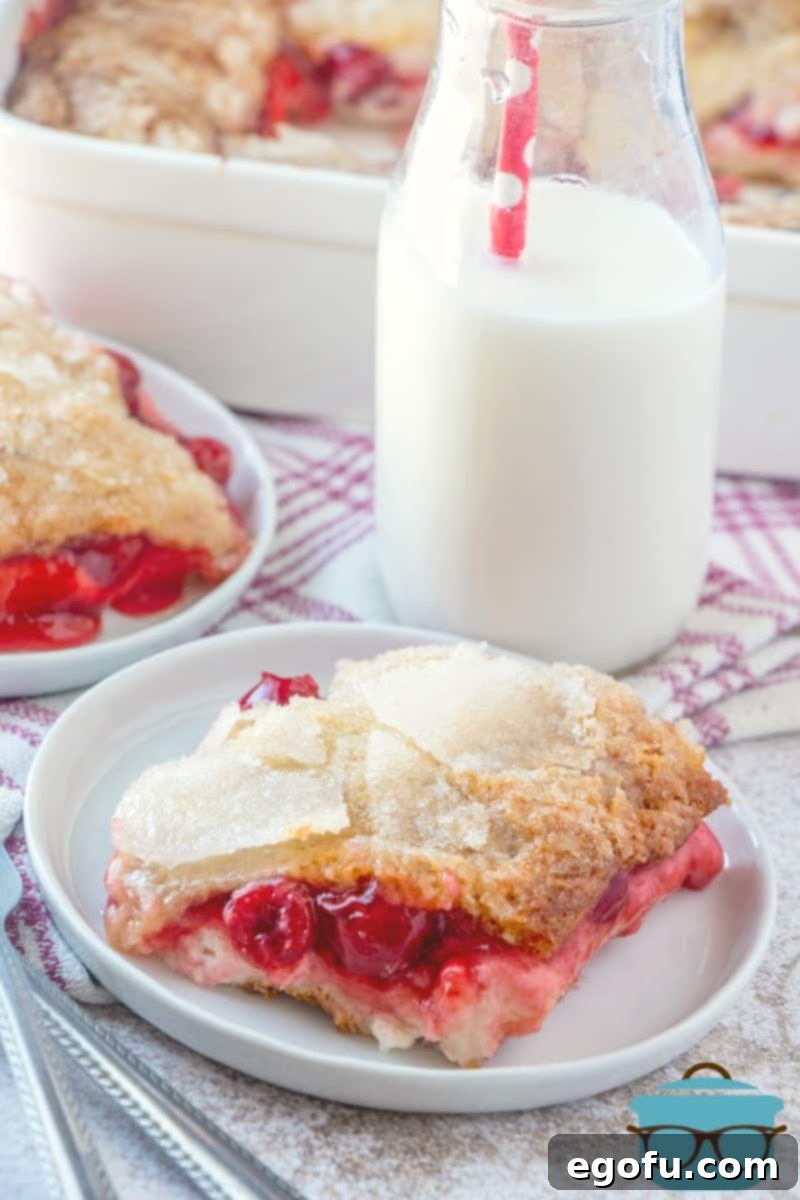 plated, crescent roll cheesecake cobbler served on a plate with milk in a bottle.