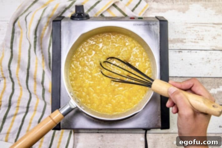 whisking pineapple mixture in a sauce pan.