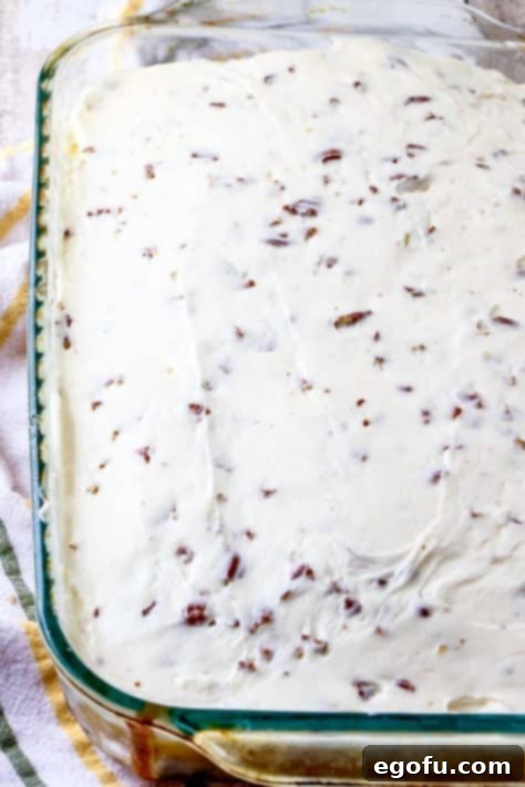 Cream cheese frosting spread onto cake.