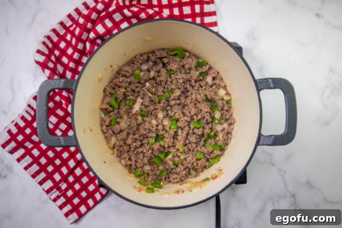 browned ground beef, onion and green pepper in a dutch oven.