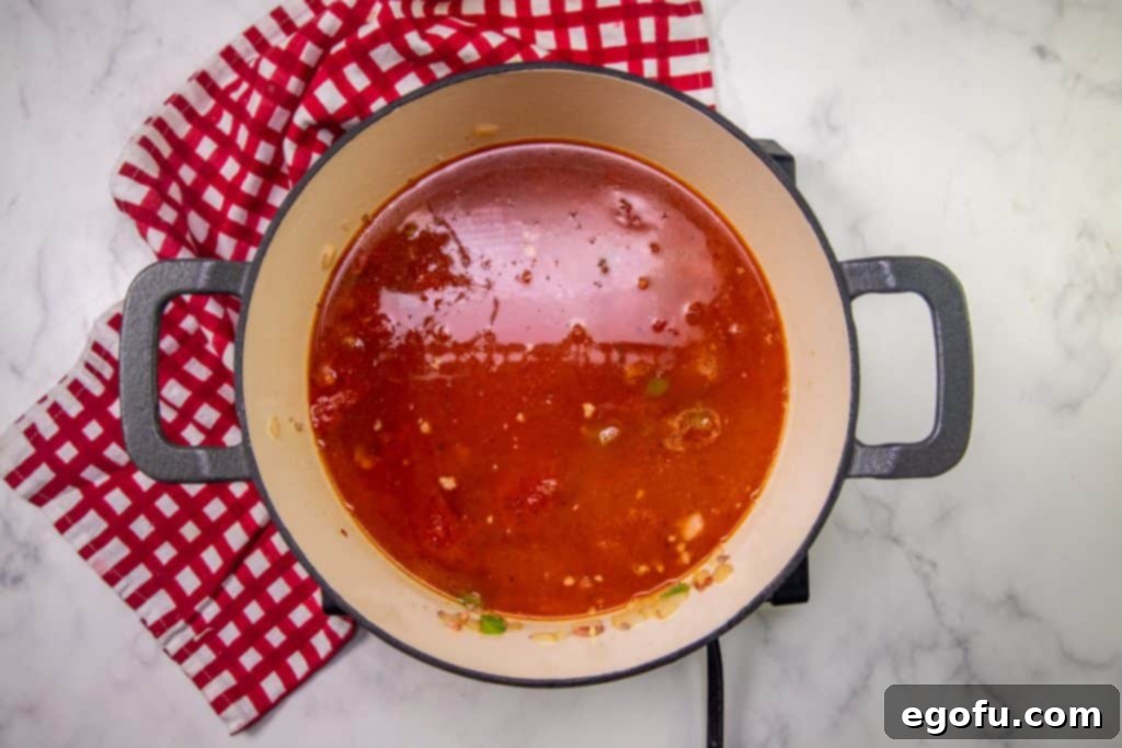 pizza sauce added to dutch oven.