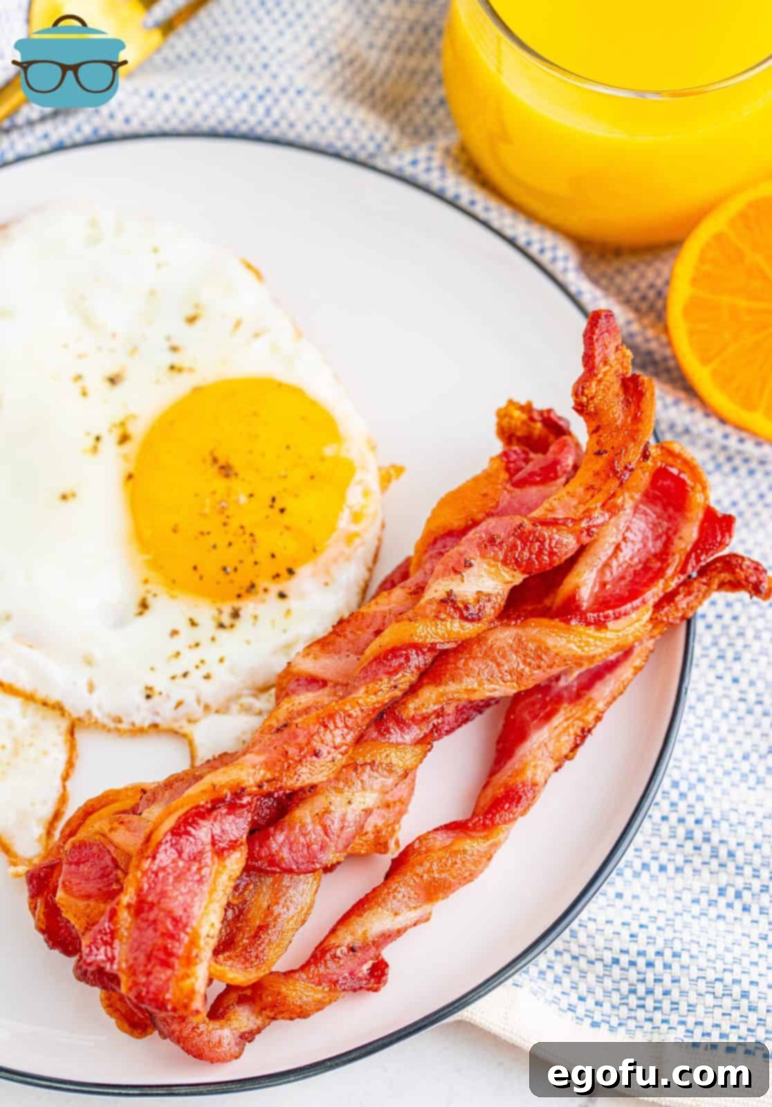 Crispy Air Fryer Bacon Spirals 7 Overhead view of a breakfast plate featuring perfectly cooked Air Fryer Twisted Bacon and scrambled eggs.